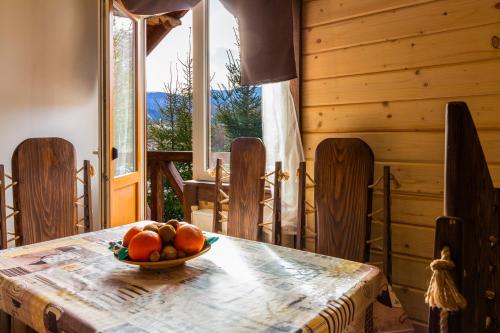 a bowl of fruit on a table in a cabin at Guest House Plai in Yaremche