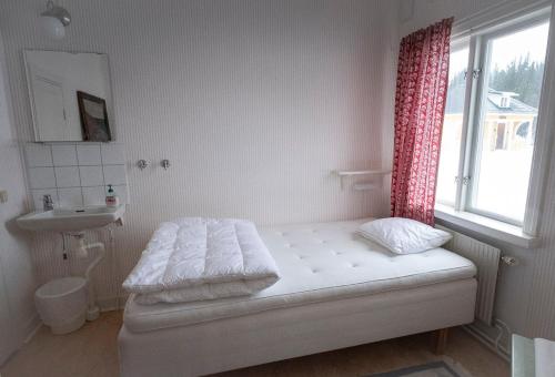 Säng eller sängar i ett rum på Enaforsholm Fjällgård