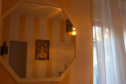 a hallway with a mirror and a picture of a deer on a wall at FiumicinoA57 in Fiumicino