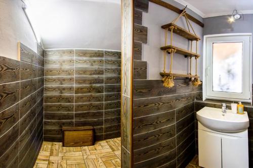 a bathroom with a shower and a sink at Guest House Plai in Yaremche