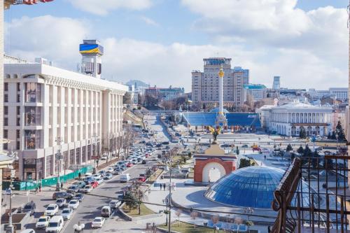 a busy city street with cars parked on the road at Partner Guest House Khreschatyk in Kyiv