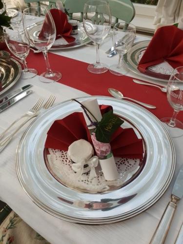 a table with white plates and silverware on a table at Gästehaus Schloss Bothmer in Schwarmstedt