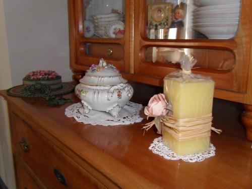 a wooden dresser with a candle on top of it at Gasthof-Pension Schütz in Wesenufer
