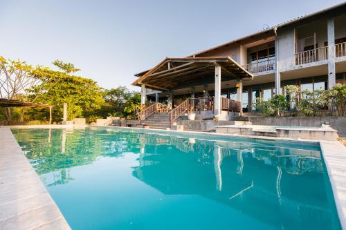 a large swimming pool in front of a building at Punta Duarte Garden Inn in Los Duarte