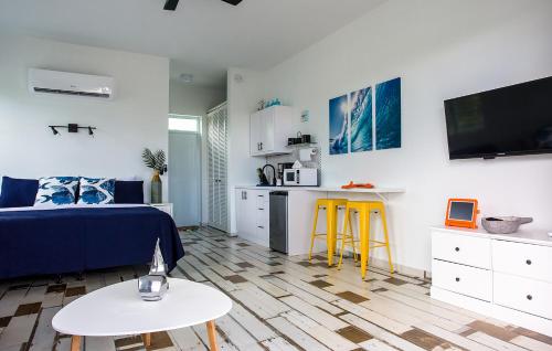 a living room with a bed and a table at The Beach Pad Puntas in Rincon