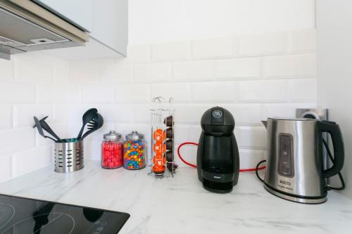 a kitchen counter with a coffee maker and a coffeemaker at Dream park in Montévrain
