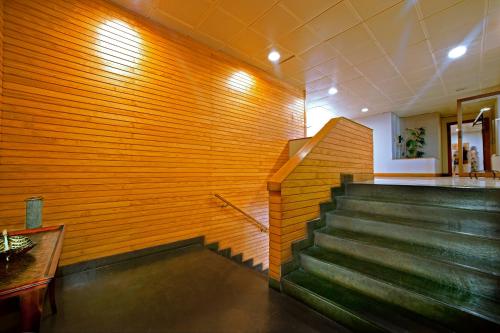 a staircase in a building with a wooden wall at Hotel Diego de Almagro Valdivia in Valdivia