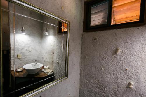 a bathroom with a sink and a mirror at Punta Duarte Garden Inn in Los Duarte