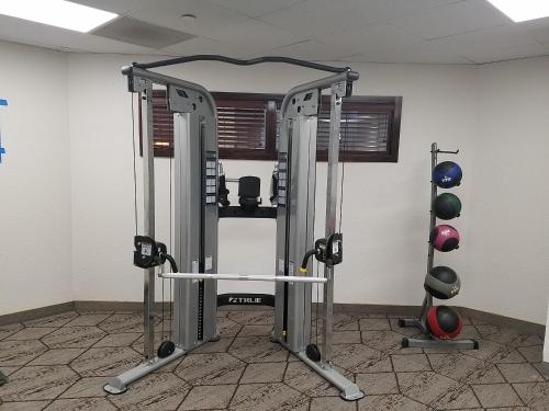 a gym with two tread machines in a room at Wingate by Wyndham Greenville Airport in Greenville