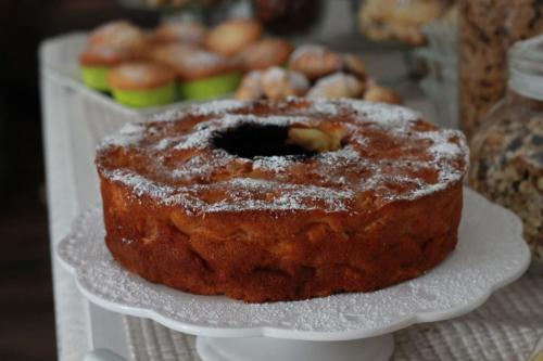 a cake on a white plate on a table at Un sogno B&B in Marghera