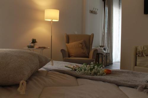 a room with a bed with a lamp and a chair at Un sogno B&B in Marghera