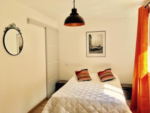 a bedroom with a bed with two pillows on it at Villa des Rubens in Grésy-sur-Aix