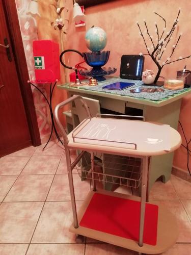 a desk with a chair and a table with a laptop at B&B melody in Fiumicino