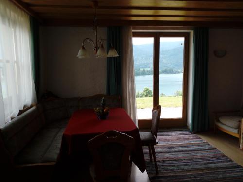 a living room with a table and a large window at Berningerhof in St. Wolfgang