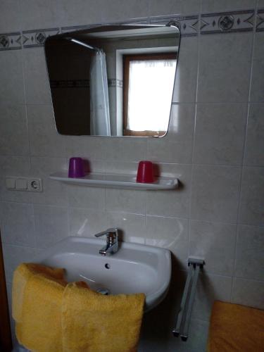 a bathroom with a sink and a mirror at Berningerhof in St. Wolfgang