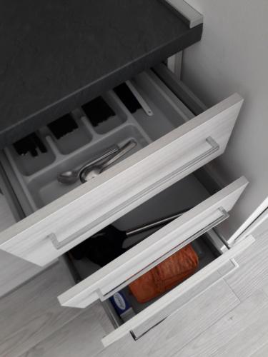 an open drawer in a kitchen with food at La CasaLina in Omegna