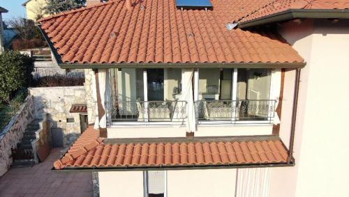 a house with an orange tile roof and a balcony at La Terrazza sul Naviglio B&B in Bernate Ticino