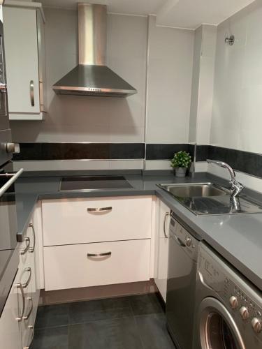 a kitchen with a sink and a washing machine at BEACH I in Gandía