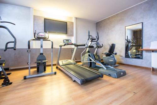 a gym with treadmills and exercise bikes in a room at Best Western Modena District in Campogalliano