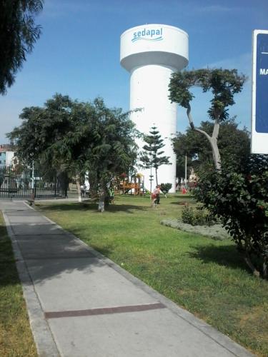 a water tower in the middle of a park at Royal Sweet Dreams Airport B&B in Lima