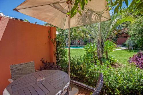 a table with an umbrella on a patio at Sitatunga Guest Lodge in Johannesburg