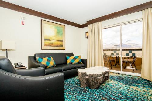 a living room with a couch and a table at Ute Mountain Casino Hotel in Towaoc