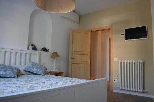a bedroom with a bed and a tv on the wall at Casa Polly B&B in Grottammare