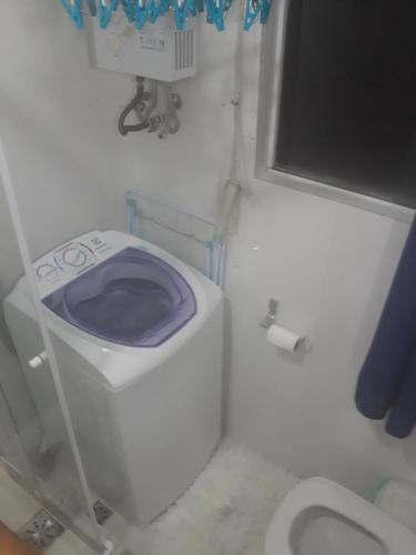 a small bathroom with a toilet with a purple seat at Apartamento de Férias Copacabana Rio de Janeiro in Rio de Janeiro