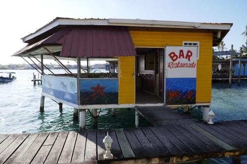 a small shack on a dock on the water at Faro del Colibri in Bocas del Toro