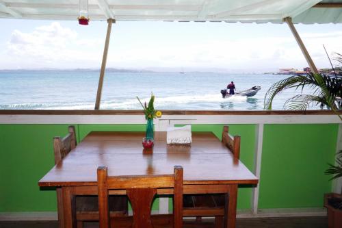 a dining table with a view of the ocean at Faro del Colibri in Bocas del Toro