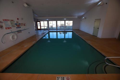 a room with a pool, a tub, and a chair in it at Ute Mountain Casino Hotel in Towaoc