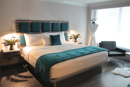 a bedroom with a large bed with a desk and a bed sidx sidx at Hotel Le Bleu in Brooklyn