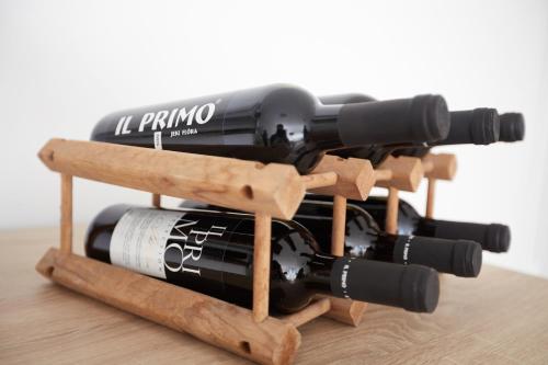 a bunch of wine bottles on a wooden rack at Panorama Apartmanok in Villány