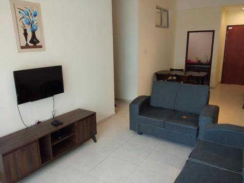 a living room with a couch and a tv at Cameron Cactus Apartment @ Pangsapuri Kaktus in Brinchang