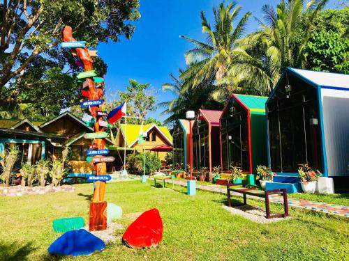a group of colorful houses in a park at Lanzones Cabana in Mambajao