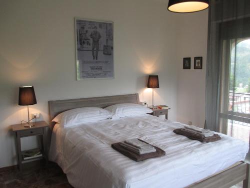 a bedroom with a large white bed with towels on it at Casa Balducci Bed&Breakfast in Mercatello sul Metauro