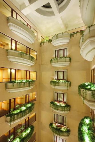 an apartment building with green plants on balconies at THE LEES Hotel in Kaohsiung