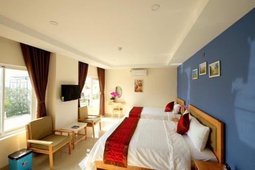 Letto o letti in una camera di Marigold Hotel & Apartment