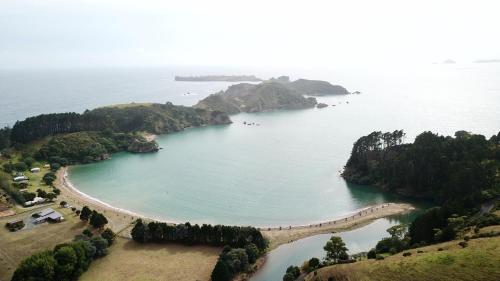 an aerial view of a bay with a beach at Waiwurrie Coastal Farm Lodge in Mahinepua