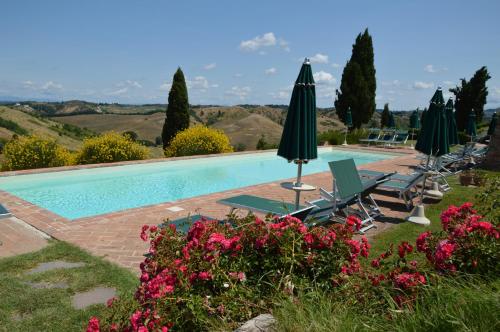 a patio area with a pool and lawn chairs at Podere Benintendi in Certaldo