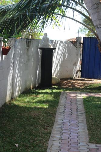 a trash can in a yard next to a fence at White Lion Paradise Dikwella in Batigama