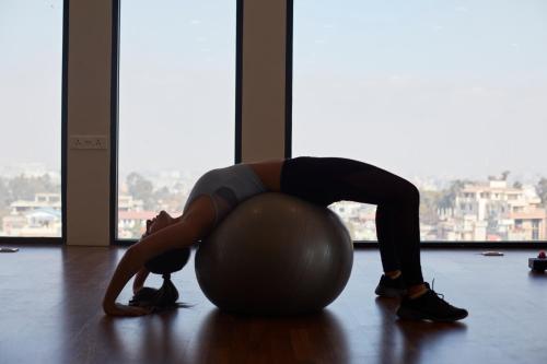 a woman is doing a push up on an exercise ball at Vivanta Kathmandu in Kathmandu