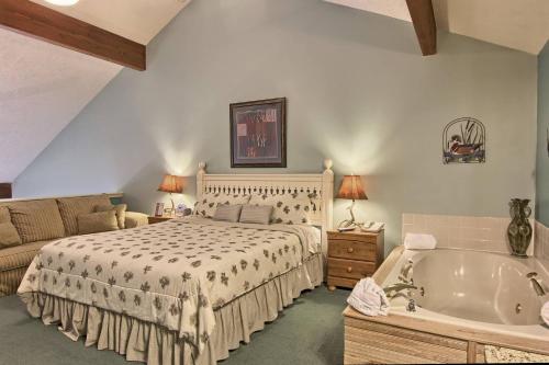 a bedroom with a bed and a bath tub at 210 Pointes North Inn in Charlevoix