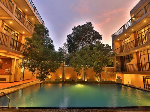 a large swimming pool in the middle of a building at ROYAL KASHYAPA - Habarana in Habarana