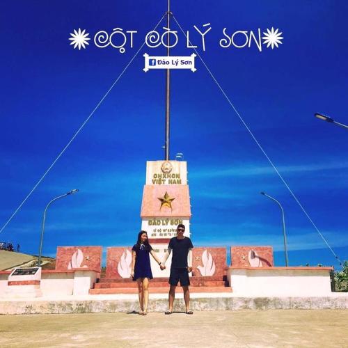 a man and woman standing in front of a monument at KHÁCH SẠN GIA THỊNH LÝ SƠN in Ly Son