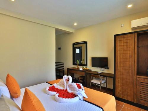 a hotel room with a bed with a towel on it at ROYAL KASHYAPA - Habarana in Habarana