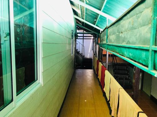 an empty hallway of a room with a window at Bang sit Guest House in Phi Phi Don