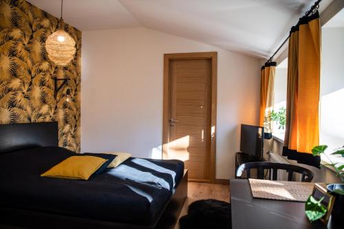 a bedroom with a bed and a desk with a computer at Liepaja Apartments in Liepāja