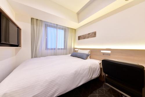 a hotel room with a bed and a television at Vessel Inn Sakae Station in Nagoya