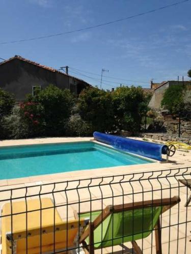 a swimming pool with blue and green water at Chambre du Charron in Azillanet